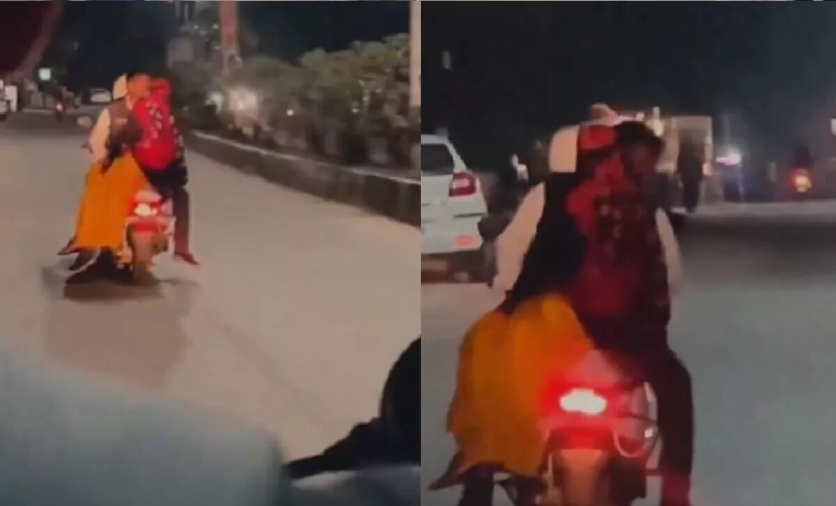 man kissing woman on scooter